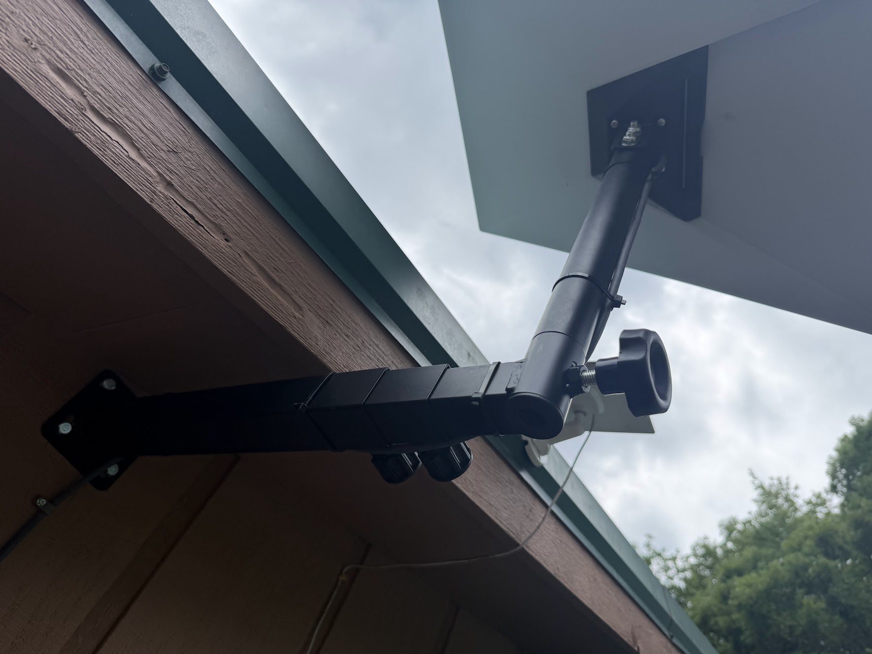 Under-eave bracket and dish photographed by Caleb Mann during installation work